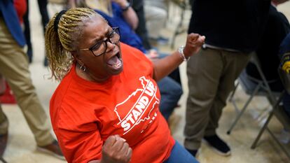 Volkswagen automobile plant employee Vicky Holloway celebrates as she watches the results of a UAW union vote, late Friday, April 19, 2024, in Chattanooga, Tenn.