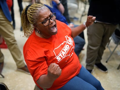 Volkswagen automobile plant employee Vicky Holloway celebrates as she watches the results of a UAW union vote, late Friday, April 19, 2024, in Chattanooga, Tenn.