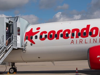 FILE - Senior cabin crew member Magdalini Michailidou stands on the gangway prior the first holiday flight of the Corendon Airlines Europe to the Greek destination Rhodos at the airport Erfurt-Weimar in Erfurt, Germany, July 2, 2020. Corendon Airlines says that it will sell an adults-only zone — no one under 16 allowed — on flights between Amsterdam and Curacao starting in November 2023. The Turkish carrier says people traveling without children will get quiet surroundings, and parents won't have to worry that their crying or fidgeting kids will annoy fellow passengers. (AP Photo/Jens Meyer, File)