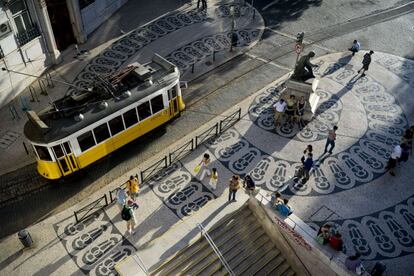 An historic number 28 tram crosses Luís Camões square in the Chiado neighborhood.