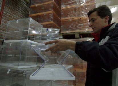 Un trabajador manipula las nuevas urnas plegables que se utilizarán en las elecciones del domingo.