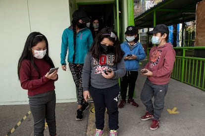 Varios estudiantes utilizan sus celulares, recién donados por la campaña de Tiberio Malaiu.