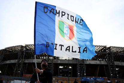 A supporter waves a flag outside the Diego Armando Maradona stadium ahead of the Serie A match between Napoli and AC Milan, in Naples, Italy, Sunday, April 2, 2023.