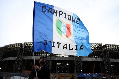 A supporter waves a flag outside the Diego Armando Maradona stadium ahead of the Serie A match between Napoli and AC Milan, in Naples, Italy, Sunday, April 2, 2023.