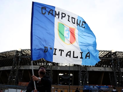 A supporter waves a flag outside the Diego Armando Maradona stadium ahead of the Serie A match between Napoli and AC Milan, in Naples, Italy, Sunday, April 2, 2023.