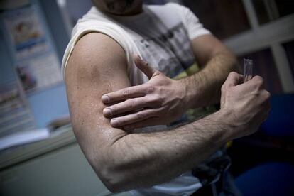 Álex, a transgender man, applies a testosterone gel.