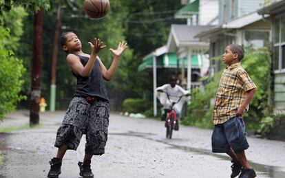 Dos ni&ntilde;os juegan al baloncesto en una calle de Akron.
 