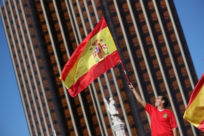 Un joven alza una bandera de España, en un momento de la concentración.