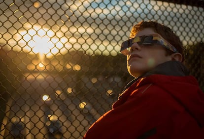 A child watches the last solar eclipse in the United States in 2014.