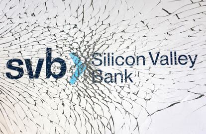 SVB (Silicon Valley Bank) logo is seen through broken glass.