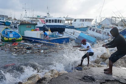 Pescadores jalan un bote dañado por el paso del huracán Beryl, en Barbados, el 1 de julio de 2024.