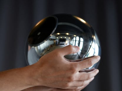 FILE PHOTO: Hands hold the biometric imaging device, the Orb, of the identity and financial public utility Worldcoin, which aims to create a World ID digital passport, with a tradeable cryptocurrency, in Berlin, Germany August 1, 2023. REUTERS/Annegret Hilse/File Photo