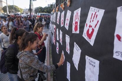 Women pay homage to the victims of male violence.