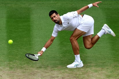 El tenista serbio Novak Djokovic trata de alcanzar una pelota.