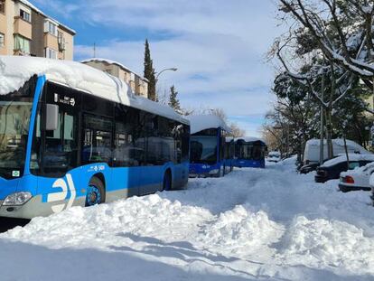 Varios autobuses de la Empresa Municipal de Transportes (EMT) de Madrid atascados tras la nevada fruto del temporal Filomena, en una calle de la capital.