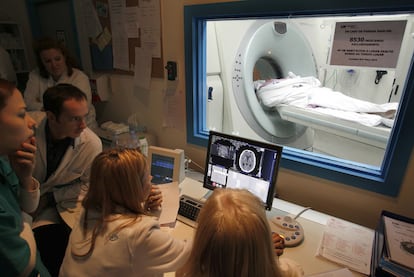 A group of physicians perform a scan to determine the extent of a patient's brain injury after a stroke.