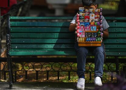 A young street vendor is taking a break in Merida city center