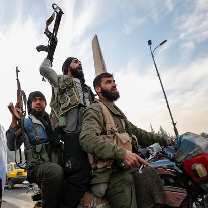 Syrian opposition fighters celebrate after the Syrian government collapsed in Damascus, Syria, Sunday, Dec. 8, 2024. (AP Photo/Omar Sanadiki)