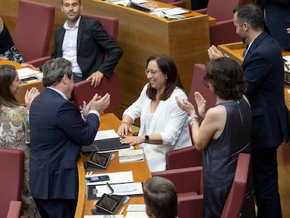 La nueva presidenta de las Cortes Valencianas, Llanos Massó, de blanco, recibe el aplauso de sus compañeros de Vox en el pleno de constitución del parlamento autonómico este lunes en Valencia.