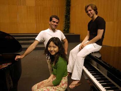 Los finalistas del concurso de piano: la china Jie Chen, el italiano Alberto Nosè y, sentado sobre el piano, el alemán Herbert Schuch.