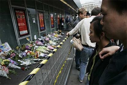 La gente observa los improvisados tributos florales dejados en las afueras de la estación de King&#39;s Cross.