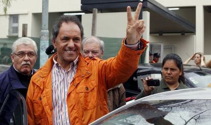 Scioli saluda tras depositar su voto.