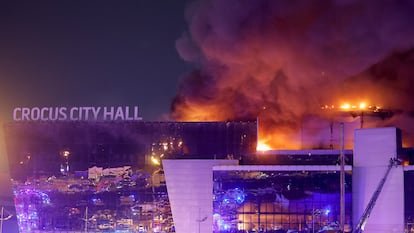 Smoke rises above the burning Crocus City Hall concert venue following a reported shooting incident, outside Moscow, Russia, March 22, 2024.