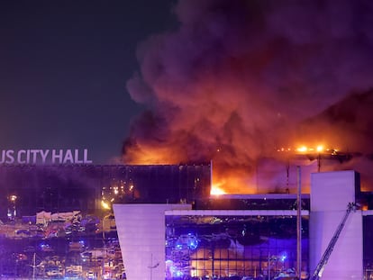 Smoke rises above the burning Crocus City Hall concert venue following a reported shooting incident, outside Moscow, Russia, March 22, 2024