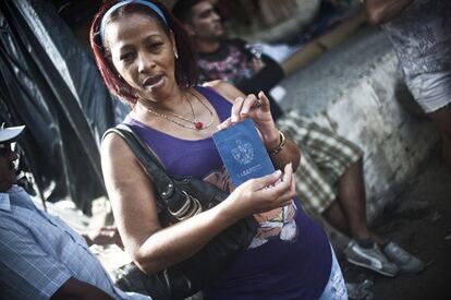 Los 8.000 migrantes bloqueados en Costa Rica esperan el traslado tras un acuerdo entre varios países centroamericanos. En la imagen, una migrante cubana que este martes 12 de enero de 2016 se trasladará en avión hacia El Salvador, muestra su pasaporte en el albergue del Fogón, en el municipio de La Cruz, Costa Rica.