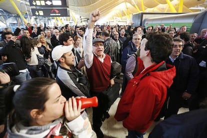 Centenares de trabajadores de Iberia realizan una concentración, hoy en la terminal T4 del aeropuerto de Barajas, de forma espontánea, ante un fuerte despliegue policial que impide el movimiento por varias zonas de la terminal, durante la segunda jornada de huelga de las 15 previstas por los empleados del la compañía contra el Plan de Reestructuración de la empresa, que contempla más de 3.800 despidos.