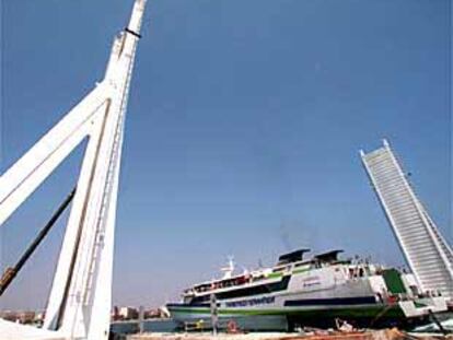 Un barco de pasajeros sale del Puerto de Valencia, ayer, a través del puente móvil construido para trenes.