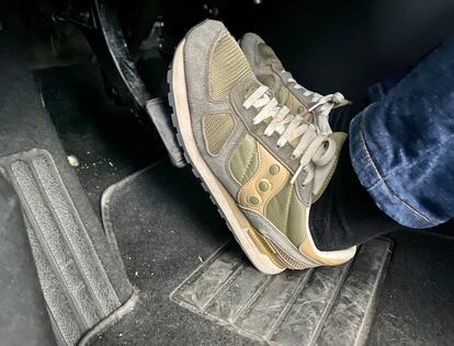 Person's feet on a car pedal