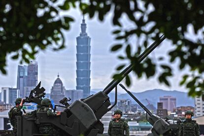 Soldados taiwaneses manipulan artillería antiaérea cerca de Taipéi, mientras China realiza ejercicios militares.