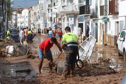 Los vecinos de Alcanar limpian el barro y arreglar los destrozos causados por el temporal en el municipio de Tarragona, este jueves.
