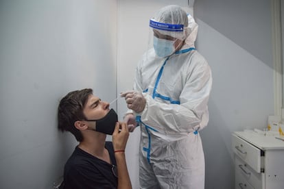 Un sanitario realiza una prueba para detectar la covid-19 en un joven en Mar del Plata, Argentina