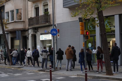 People wait in line for a coronavirus test at a private clinic in Spain.