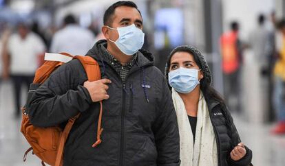 Algunos pasajeros con cubreboca en el aeropuerto de Ciudad de México.