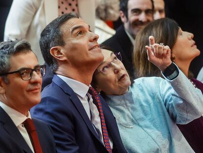El presidente del Gobierno, Pedro Sánchez, atiende unas indicaciones de la presidenta de la Comisión Nacional de los Mercados y la Competencia, Cani Fernández Vicién.