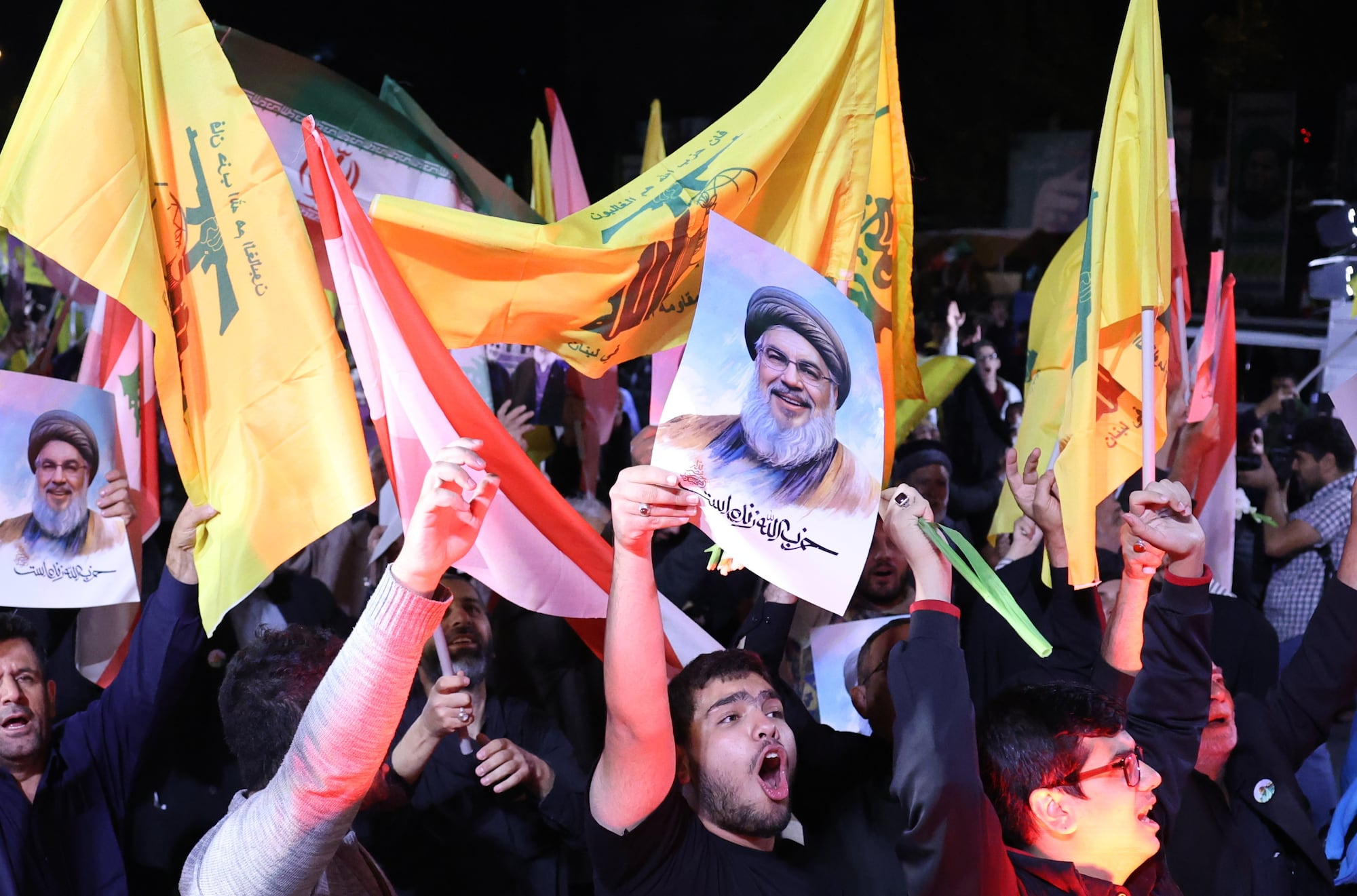 Tehran (Iran (islamic Republic Of)), 01/10/2024.- Iranians hold pictures of late Hezbollah leader Hassan Nasrallah as they celebrate after Iran launches missiles towards Israel, at the Palestine Square in Tehran, Iran, 01 October 2024.Iran has launched dozens of missiles directed at Israel on 01 October 2024, state media reported quoting the Islamic Revolutionary Guard Corps (IRGC). The attack was a 'retaliation for different assassinations' carried out by Israel and 'the crimes in Palestine and Lebanon', IRGC said. (Líbano, Teherán, Hizbulá/Hezbolá) EFE/EPA/ABEDIN TAHERKENAREH
