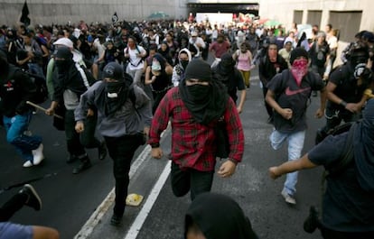 Masked demonstrators at a protest on October 2, 2013 in Mexico City.