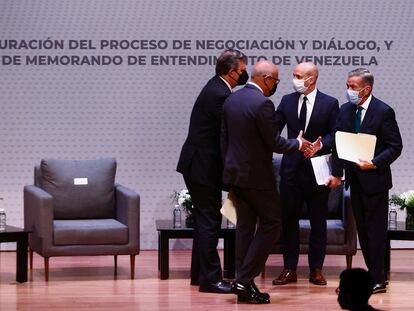 El jefe de la oposición y un delegado del Gobierno venezolano se saludan tras las reuniones en Ciudad de México.