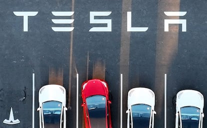 An aerial view shows cars parked at the Tesla Fremont Factory in Fremont, California, on February 10, 2022.