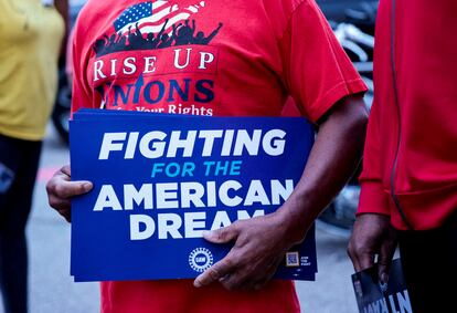 United Auto Workers union member holds a sign outside Stellantis Sterling Heights Assembly Plant, to mark the beginning of contract negotiations in Sterling Heights, Michigan, July 12, 2023.