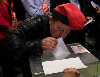 A man kisses his ballot paper before voting in Barcelona.