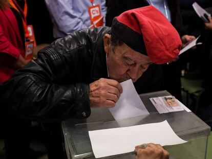 A man kisses his ballot paper before voting in Barcelona.