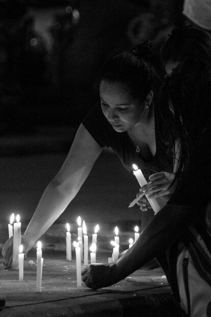 Os moradores do Alemão acendem velas durante o protesto.