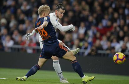 Gareth Bale dispara, ante la oposición de Daniel Wass.