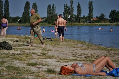 Civiles y militares disfrutan de la playa de un lago en Sloviansk, a una veintena de kilómetros de la línea del frente