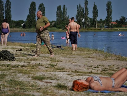Civilians and soldiers enjoy the lake in the Ukrainian city of Slovyansk, about 12 miles from the frontlines.
