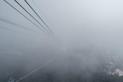 A cable car passes through the clouds on its way to Sugarloaf Mountain.